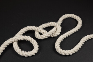 Rope with a knot on dark background