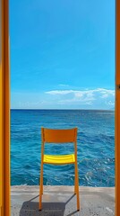 Fototapeta premium Yellow chair facing the sea from a balcony