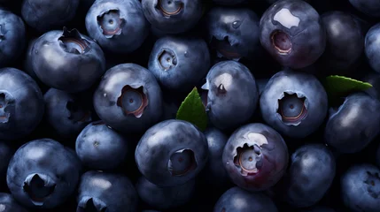 Fotobehang a pile of blueberries with a green leaf © Irina
