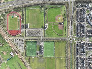 Aerial drone top down view on sports field, amateur sports grounds. Birds eye top down overview. Recreation leisure and health lifestyle.