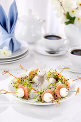  Appetizer quail egg stuffed with alfalfa sprouts with a slice of salmon, on a wooden skewer. Buffet serving for the Easter table.