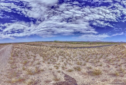 Panoramic picture over the Namibian Kalahari with blue sky and light clouds