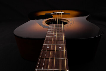 Acoustic guitar. Black background. 
horizontal photo. Photo for background