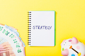 Strategy headline in notebook on yellow background