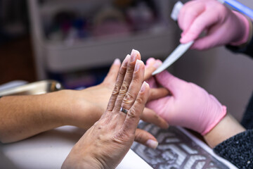 Close-up of nail filing during manicure session