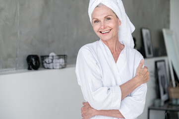 Satisfied smiling 50 years old woman after bodycare procedures at spa salon