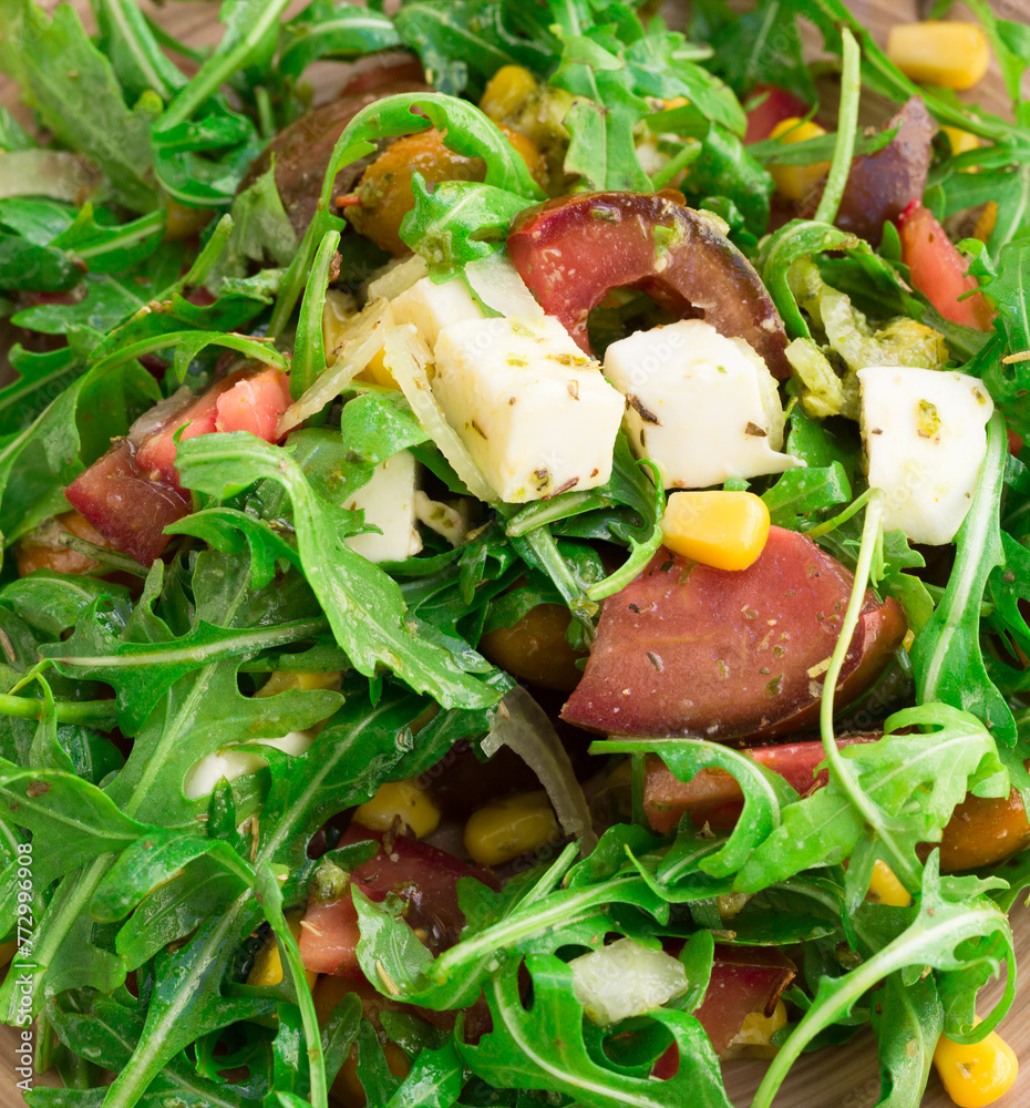 Wall mural Mixed salad of arugula and fresh vegetables with sauce