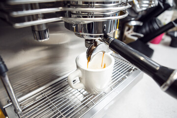 Professional Barista Crafting Strong and Dense Espresso in Modern Coffee Machine