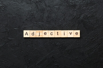 adjective word written on wood block. adjective text on cement table for your desing, concept