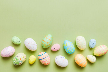 decorative easter eggs on colored background. easter eggs collection top view with copy space