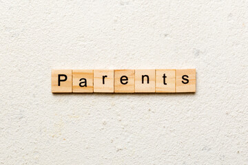 Parents word written on wood block. Parents text on cement table for your desing, concept