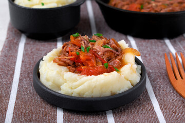 Stewed meat with potato mash served on the plate. Nutritious meal for lunch or dinner - 773008154