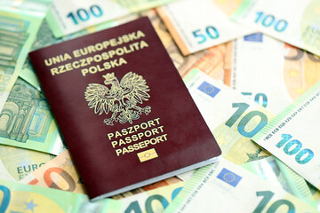 Red polish passport and big amount of european euro money bills close up