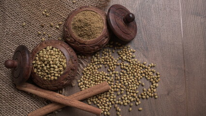 Dry coriander seeds with small bamboo spoon and green fresh bunch coriander leaves,famous spices ingredients in asia's kitchen.