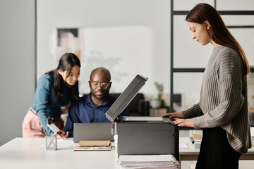 Young Woman Making Copy Of Document