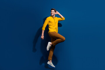 Full body photo of handsome young guy jumping dance discotheque wear trendy yellow outfit isolated...
