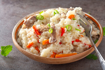 Hearty bowl of rice and vegetables with chicken meat