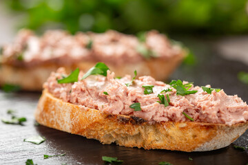 Pork pate on toasted bread with fresh herbs