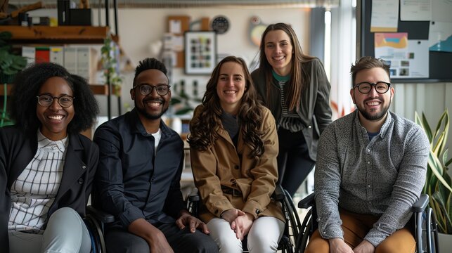 Inclusive office team portrait: diverse group with cheerful smiles and wheelchair user