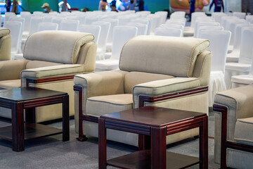 Close-up of VIP sofa seats in the first row of a large business conference