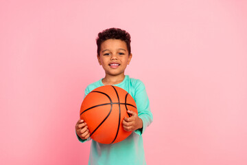 Photo portrait of cute little boy play basketball game wear trendy aquamarine clothes isolated on pink color background - obrazy, fototapety, plakaty