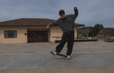 Skateboarder mastering balance in urban plaza, copy space.