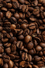 coffee beans are on table after roasting. Fresh converted coffee beans before packing in paper bag. Ground coffee for making Americano or cappuccino. grain cultivation and harvesting