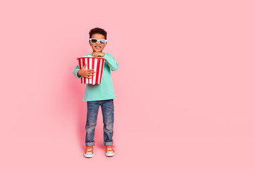 Full length photo of adorable little boy eat popcorn bucket watch film wear trendy aquamarine...