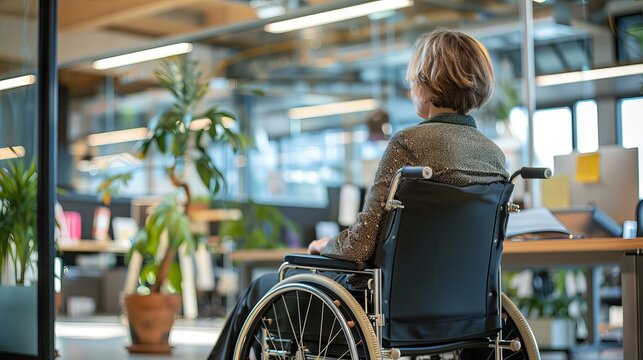 Inclusive workplace environment: experienced senior Businesswoman with disability leading team from wheelchair