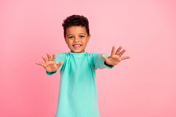 Photo portrait of charming small boy stretch hands want hugging wear trendy aquamarine outfit isolated on pink color background