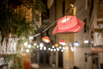 Hanging red hat-lantern on the street of the old town of Bari. Italy