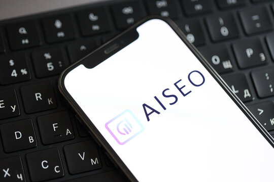 KYIV, UKRAINE - MARCH 17, 2024 AISeo logo on iPhone display screen and MacBook keyboard. Artificial Intelligence engine