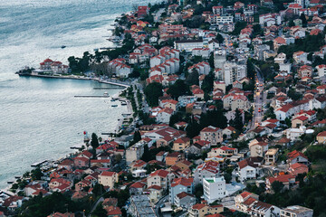 Dusk descends on Kotor, Montenegro, highlighting urban coastal charm, suitable for lifestyle and...