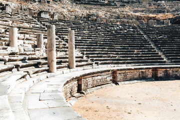 Miletus ancient theater stage and sits rows. Scenic view on the ancient ruins at bright summer day....