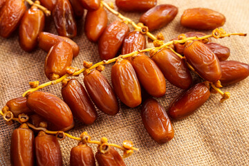 Sweet dried dates on a rustic sack cloth