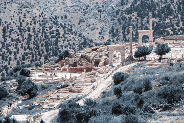 Sagalassos ancient city ruins, stone columns, arches, pathways, nestled in mountains. Toning....