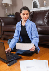 Eastern European Woman with a laptop looking at a data visualization report. Business work from home consept.