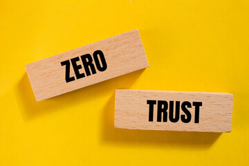 Zero trust words written on wooden blocks with yellow background. Conceptual symbol. Copy space.