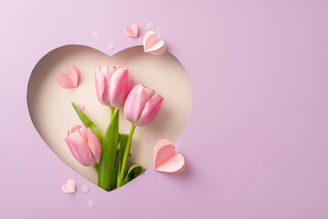 Trendy Mother's Day top view setup: Fresh tulips, paper hearts, confetti visible through...