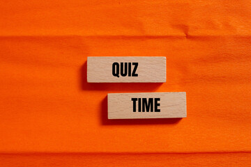Quiz time words written on wooden blocks with orange background. Conceptual symbol. Copy space.