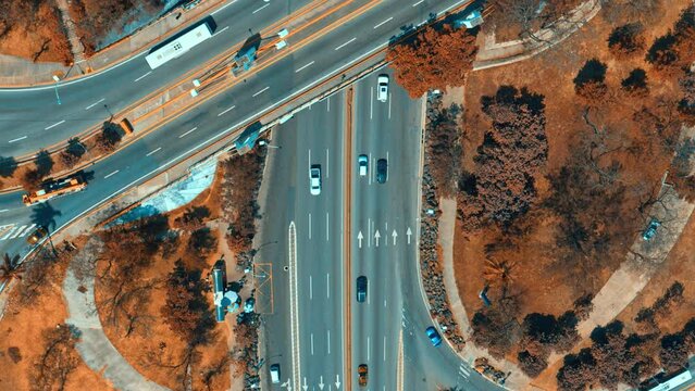 A busy multi-level highway interchange - top view. Important infrastructure. Aerial view of modern transport with expressway. City crossroads. The video is tinted.
