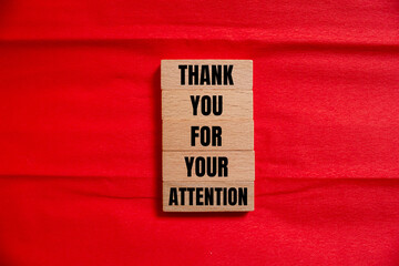 Thank you for your attention words written on wooden blocks with red background. Conceptual symbol. Copy space.