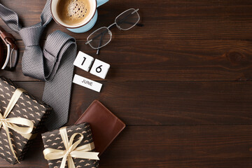 Top view treasures for dad: Stylish gifts and a warm cup of coffee arranged on a wooden background for Father's Day with space for your message - Powered by Adobe
