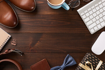 Father's day at the office: Overhead snapshot of business essentials and gifts on a rich wooden desk, ready for the fatherly festivities - obrazy, fototapety, plakaty