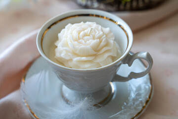 Rose shaped white soy wax candle in tea cup