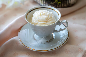 Rose shaped white soy wax candle in tea cup