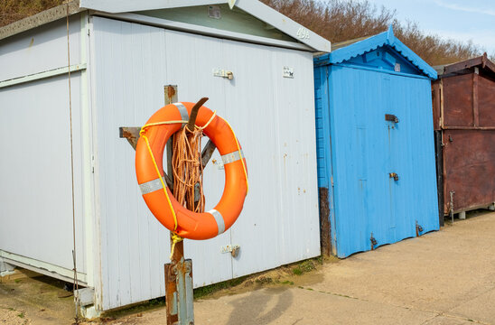  Orange life saver ring outside a wooden beach hut on Clacton promenade