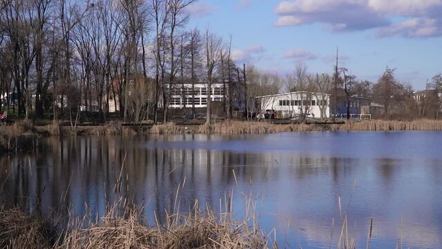 Beautiful peaceful lake Bubanj surrounded with trees and buildings in Kragujevac