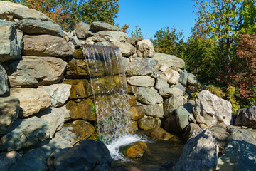 Beautiful waterfall in Japanese garden. Public landscape park of Krasnodar or Galitsky park, Russia.