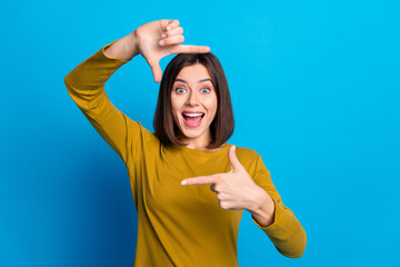 Photo of excited cheerful lady dressed shirt showing fingers photo gesture empty space isolated blue color background